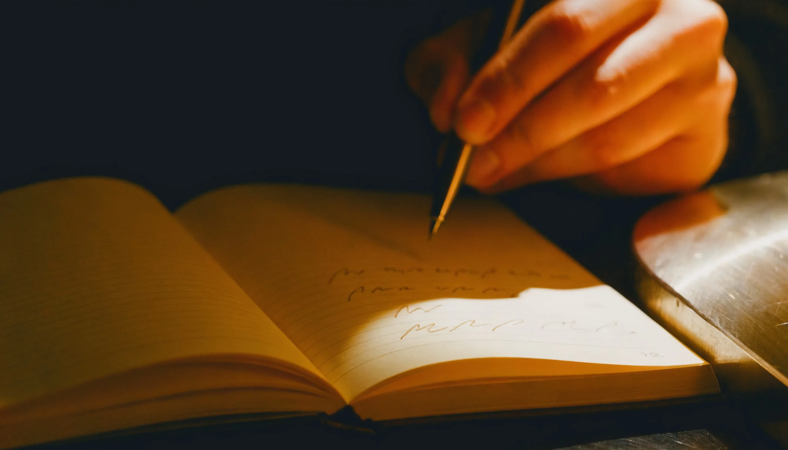 A lab notebook open beside an instrument, a human hand mid-annotation: the record of who conceived what, which is the thing the law asks for.