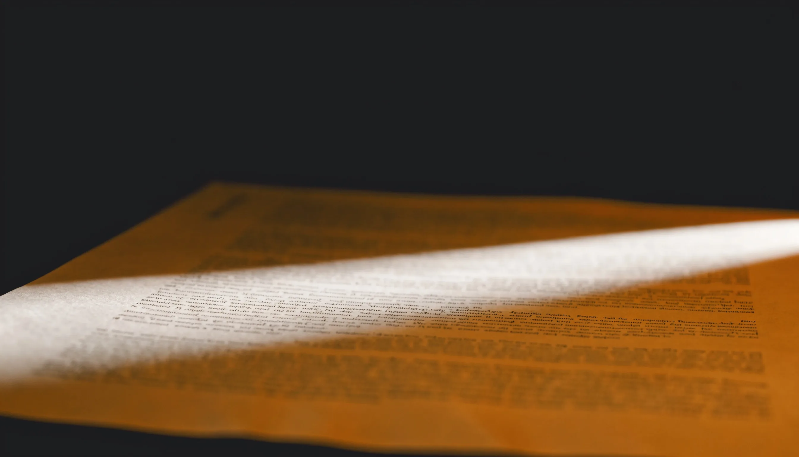 A page of technical specification text under raking light, the paper itself unmarked: the pattern is in the choice of words, not in anything added to the page.